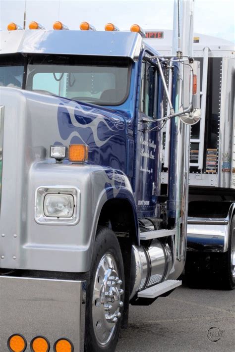 A Blue And Silver Semi Truck Parked In A Parking Lot