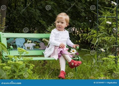 Little Blond Toddler Girl On A Bench Royalty Free Stock Photography