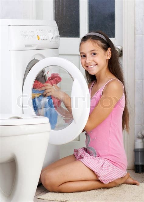 The Young Girl Is Washing Clothes Stock Photo Colourbox