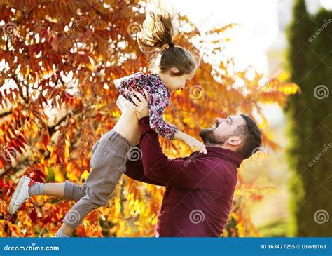 Dad With His Daughter In The Autumn Park Walks Stock Image Image Of