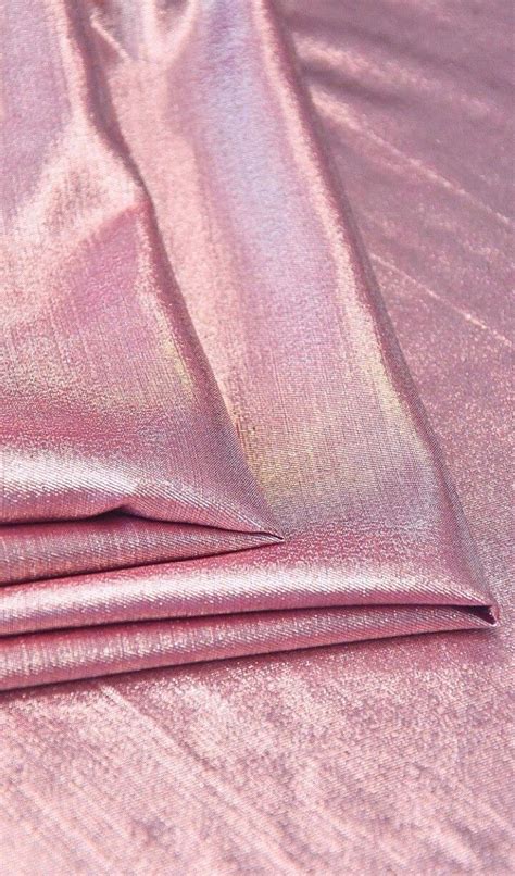 The Pink Sheets Are Folded On Top Of Each Other In This Close Up Photo