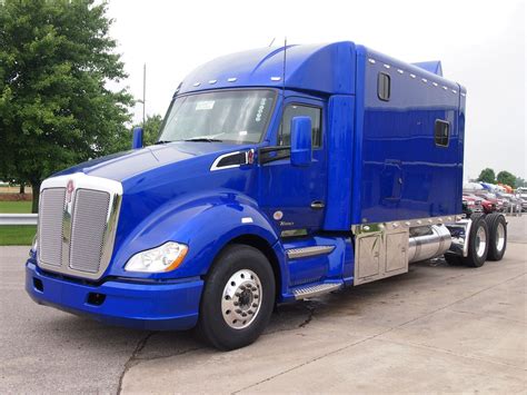 A Blue Semi Truck Parked In A Parking Lot