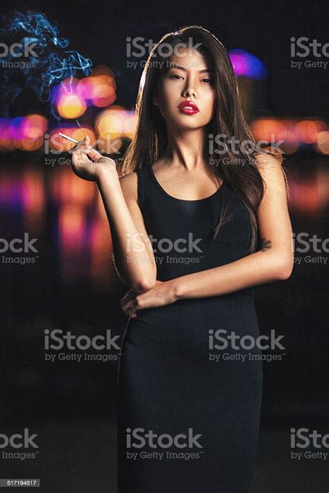 Beautiful Asian Lady Smoking Night City Behind Her Stock Photo