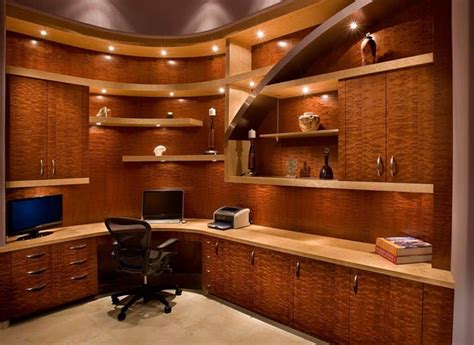 A Home Office With Built In Shelving And Lighting