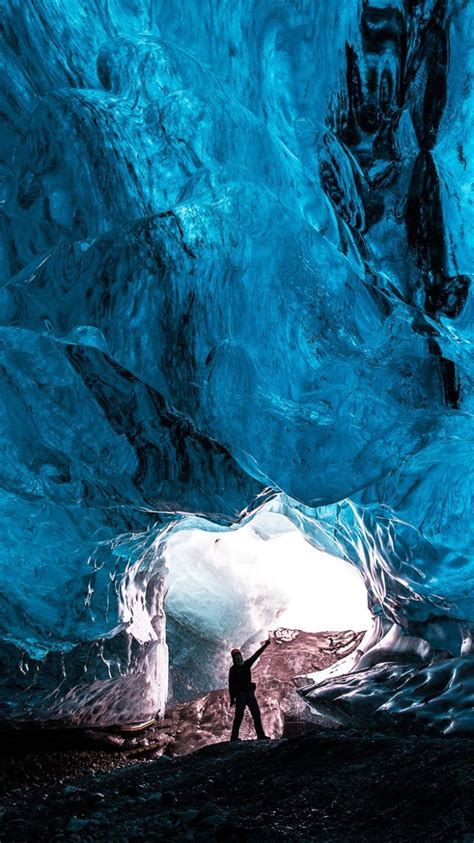 Download 750x1334 Cave Blue Ice Crystals Man Glowing