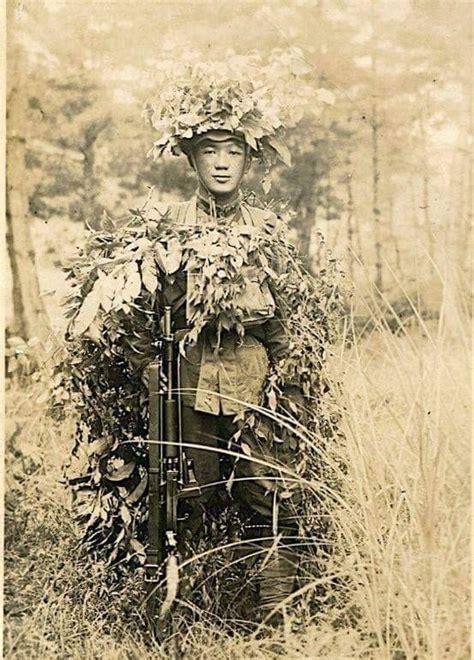 A Japanese Army Infantryman In Heavy Camouflage During A Training