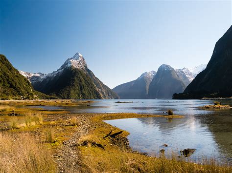 Rippling Body Of Lake Water Over Looking Mountains Mitre Peak Hd