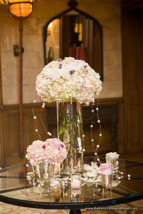 Tall And Low Centerpieces Of Blush And Ivory Hydrangea And Roses With