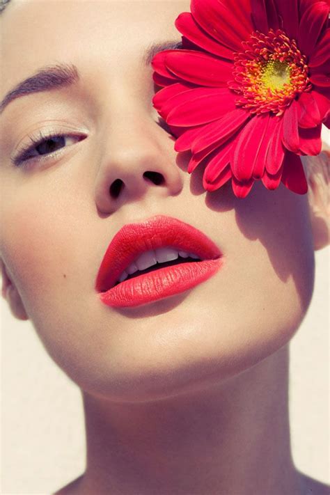 A Woman With Red Lipstick And A Flower In Her Hair