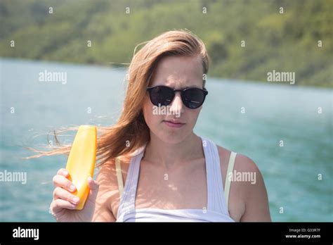 Suntan Lotion Woman Applying Sunscreen Smiling Happy In Bikini On Hot
