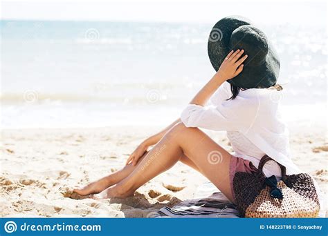 Choose from a wide range of similar scenes. Stylish Hipster Girl In Hat Sitting On Beach With Straw ...