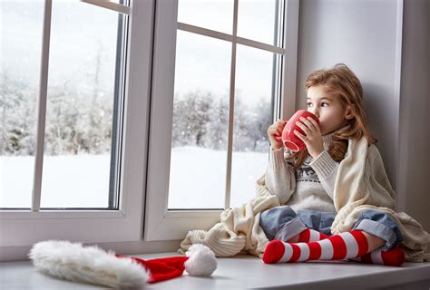 A cute young woman looks out the window and greets someone, close up, daylight. Staying Hydrated During Winter Months: Are You Drinking ...