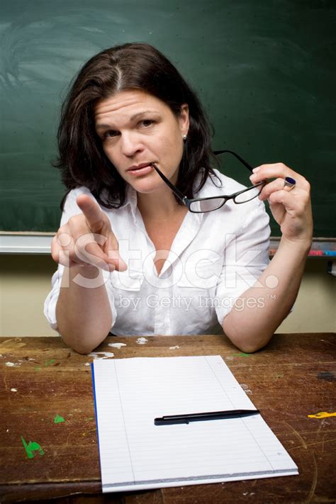 Female Teacher Looking Serious And Pointing Stock Photo Royalty Free