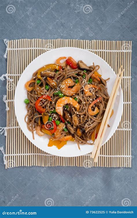 Plate Of Asian Buckwheat Noodles With Seafood And Vegetables Stock