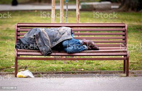 Homeless Man Sleeping On A Bench Stock Photo Download Image Now