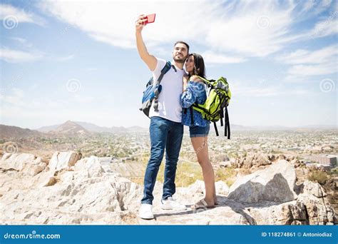 Cute Couple Hikers Taking Selfie On Top Of The Mountain Stock Image