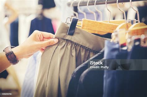 Hand Of Customer Choosing Skirts In A Clothing Store Stock Photo
