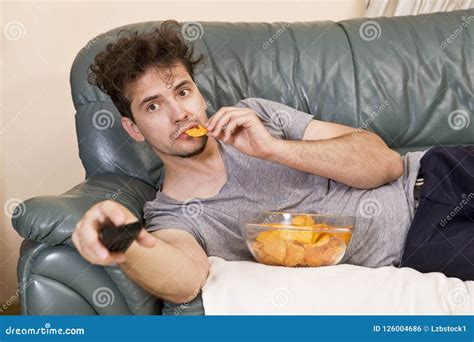 Lazy Man With The Remote And Chips On The Couch Stock Photo Image Of