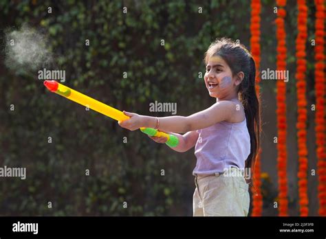 Little Girl Child Celebrating Holi With Pichkari Stock Photo Alamy