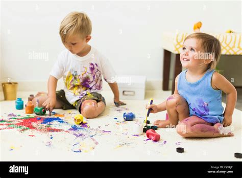 Children 2 3 Painting On Carpet Stock Photo Alamy