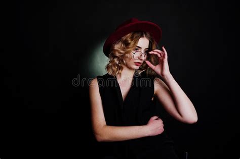 Studio Portrait Of Blonde Girl In Black Wear Red Hat Stock Image