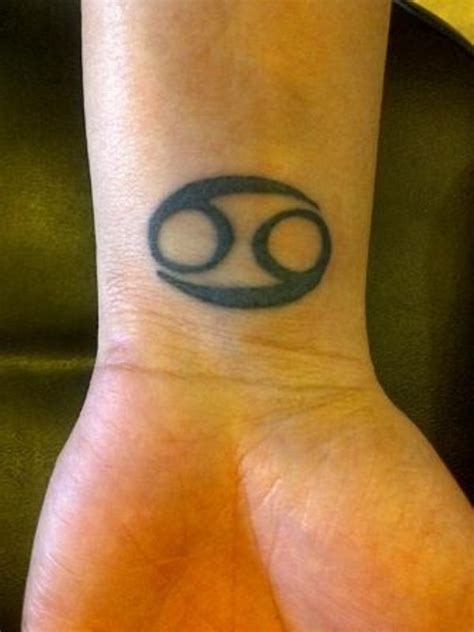 Small cancer zodiac symbol tattoo. 54 Elegant Zodiac Sign Wrist Tattoos