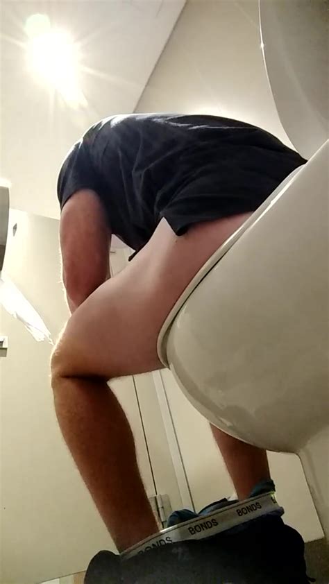 Man Reading On Toilet