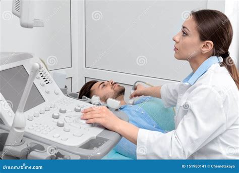 Doctor Conducting Ultrasound Examination Of Patient`s Neck Stock Image