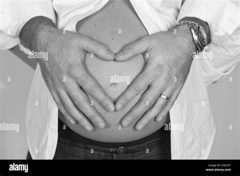 Fathers Hands On Mothers Pregnant Belly Stock Photo Alamy