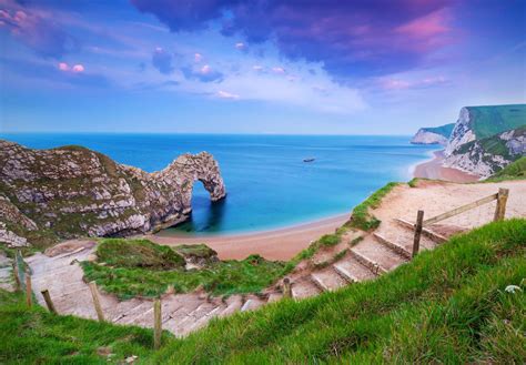 Lulworth Cove And The Natural Limestone Arch Of Durdle Door Are Two Of