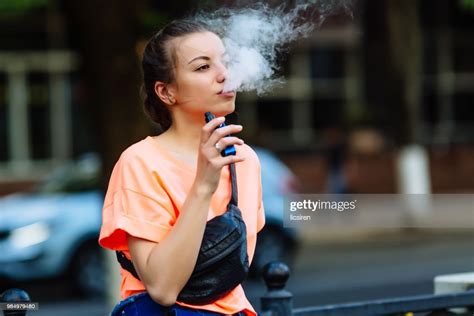 Pretty Young Hipster Woman Vape Ecig Vaping Device At The Sunset Toned Image High Res Stock