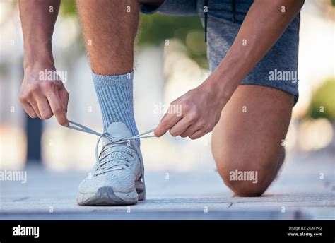 Fitness Running And Tie Shoes Of Man In Street For Training Exercise And Health Lifestyle