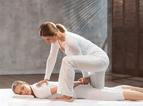 Professional Masseur Doing Thai Massage Therapist Is Making Body Stretching Exercises To The
