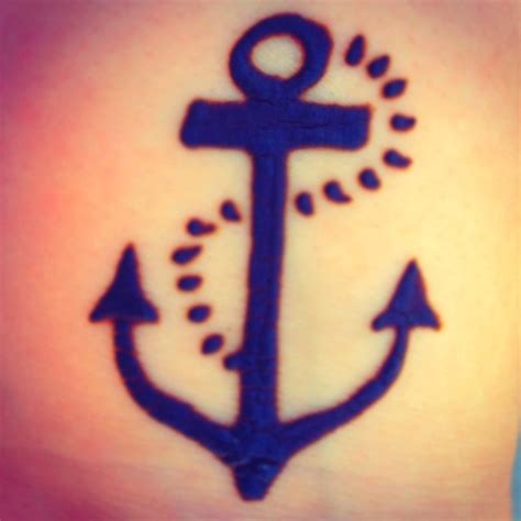 An Anchor Tattoo On The Back Of A Womans Stomach With Water Drops
