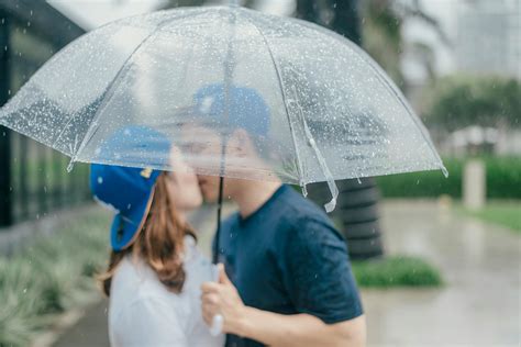 Couple Kissing Under Umbrella · Free Stock Photo