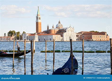 San Giorgio Maggiore Basilica With Gondola Passing In Venice At Sunset