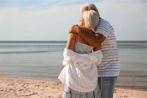 Mature Couple Spending Time Together On Beach Back View Stock Image