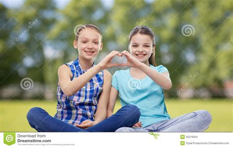 Happy Little Girls Showing Heart Shape Hand Sign Stock Photo - Image ...