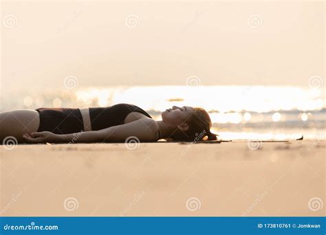 Vacation Of Beautiful Attractive Asian Woman Relaxing In Yoga Savasana Pose On The Beach With