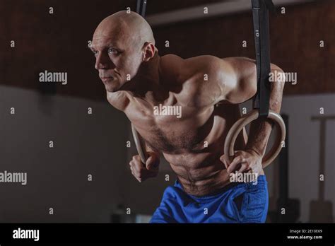 Muscular Mature Male Crossfit Athlete Doing Ring Dips Copy Space Shirtless Sportsman With Six