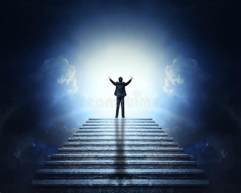 A Man In A Suit With Arms Outstretched On A Stone Staircase To The