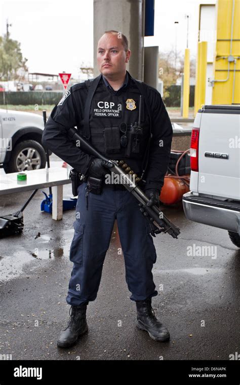 A Us Customs And Border Protection Officer Watches The San Luis Stock