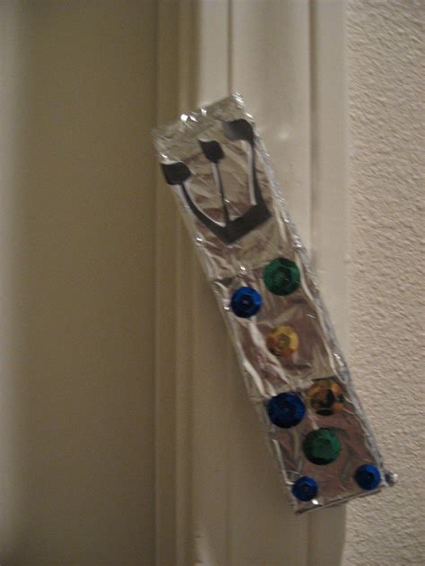 A Plastic Bag With Buttons Attached To It Hanging On The Wall Next To A