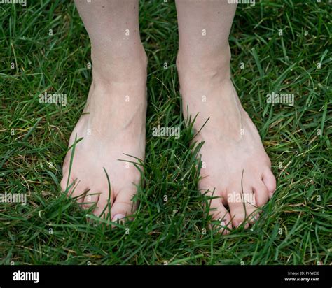 Woman Standing On The Grass With Bare Feet Walking Barefoot Grounding