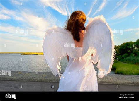 Guardian Angel Woman From Back Water At Dusk Stock Photo Alamy