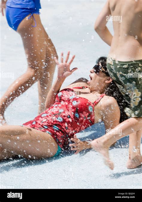 Woman Getting Splashed At A Waterpark Stock Photo Alamy
