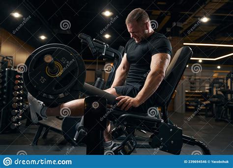 Strong Weightlifter Working Out On Exercise Equipment Stock Photo
