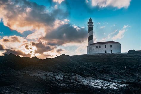 Lighthouse During Dawn In A Winter Day With Cloudy Sky Stock Photo