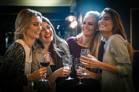 Cheerful Female Friends Enjoying Drinks In Bar Stock Photo Download