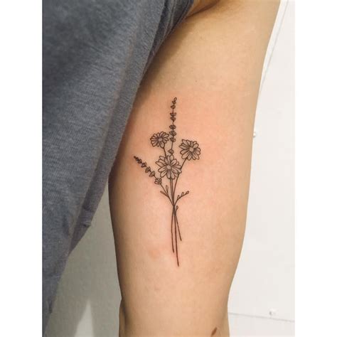 A beautiful and popular tattoo idea for women is the sunflower. Tiny daisy & lavender bunch!… | Lavender tattoo, Tattoos, Bouquet tattoo